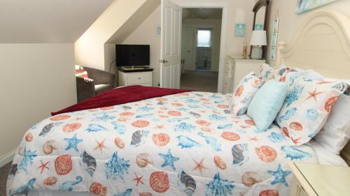 a bedroom with a large bed with blue and red pillows at 324 First Ave in West Cape May