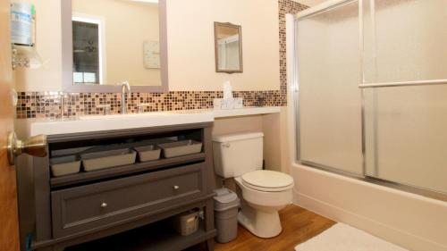 a bathroom with a toilet and a sink and a shower at 202 Ocean Unit 6 in Cape May Point