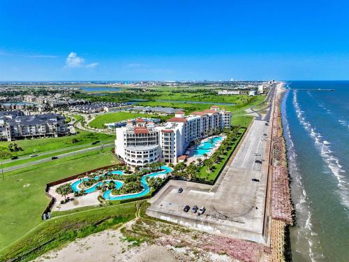 an aerial view of a resort next to the ocean at PH, Balcony, Lazy River, I-O Pools, Game Room, Spa, Beach, Luxury 2-2 Penthouse! in Galveston