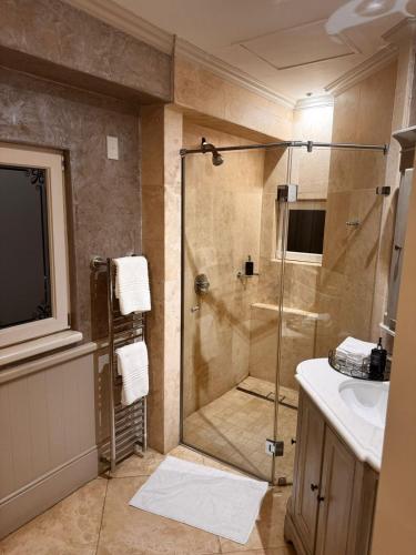 a bathroom with a shower and a sink at The 506 Hotel in Midrand