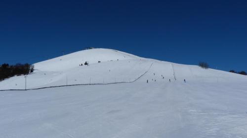 a group of people skiing down a snow covered slope at Apartmány Bea Donovaly in Donovaly