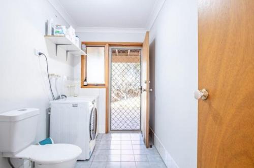 a bathroom with a toilet and a sink and a door at Sapphire House in Mirador
