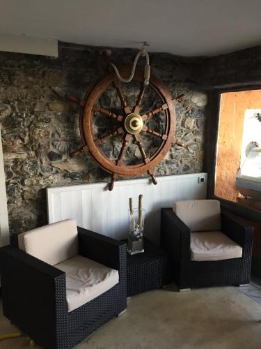 a room with two chairs and a wheel on the wall at Stella Maris Resort in Camogli