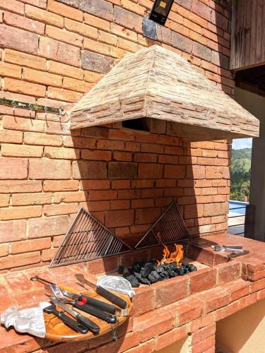 a brick oven with tools on top of it at Brisal Mountain Retreat in Jarabacoa