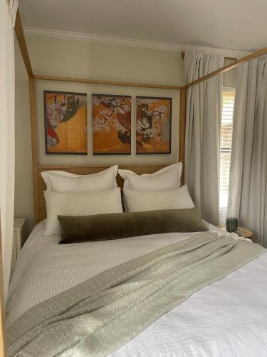 a bedroom with a large bed with white pillows at The Tamara Suite in Pensacola
