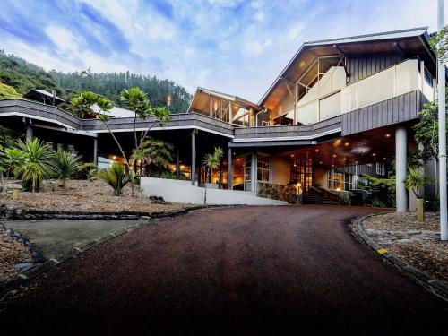 a large building with a road in front of it at Grand Mercure Puka Park Resort in Pauanui