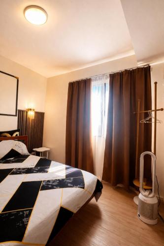 a bedroom with a bed and a window with curtains at Mon Amour Haven - 1BR Taytay Rizal in Taytay