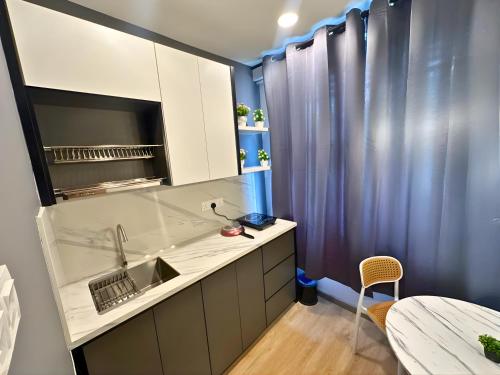 a kitchen with a sink and a counter top at Seeds Hotel Bukit Bintang in Kuala Lumpur