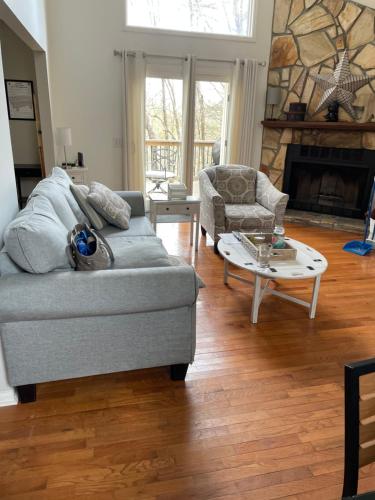 a living room with a couch and a coffee table at Golf, Hot tub, Arcade, Poker Table, Wildlife, Internet, Pet Friendly, Name-May the Course Be With You in Ellijay