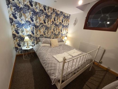 a crib in a room with blue and white wallpaper at Ramsgate Sea-side Stay! in Ramsgate