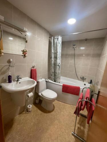 a bathroom with a sink and a toilet and a bath tub at Ramsgate Sea-side Stay! in Ramsgate