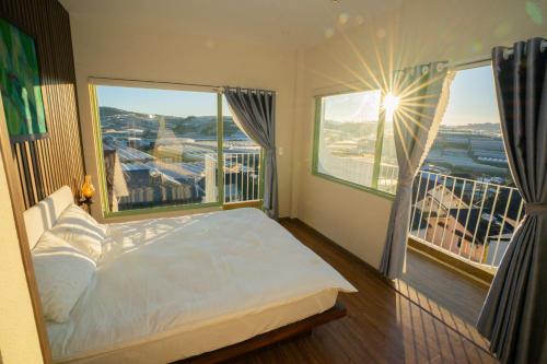 a bedroom with a bed and a large window at Mộc Villa DaLat in Khu Chi Lăng