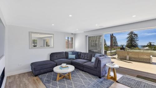 a living room with a couch and a table at Avoca Dream in Avoca Beach