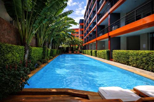 a swimming pool in the middle of a building at LUMA Condo 1BR Open View NBC Nai Harn in Rawai Beach