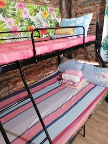 a bunk bed in a room with pillows at Maraño's Home in Legazpi