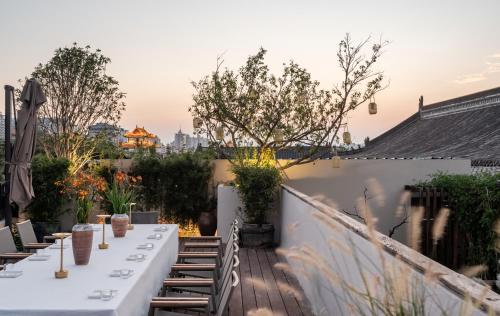 a table on a rooftop with a view of the city at 垣里民宿The hotel under the city wall in Xi'an