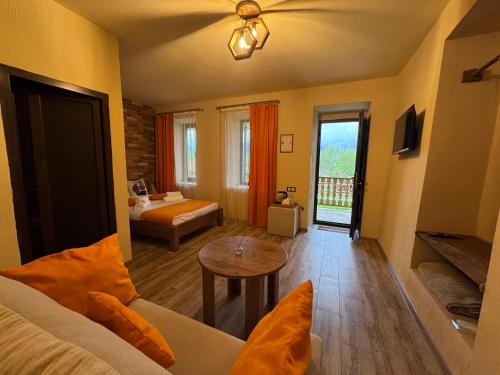 a room with a bedroom with a bed and a table at Moon Valley Guest House in Margahovit