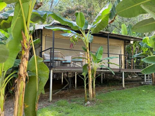 a house with a deck in the yard at KRITAJNA SAFARi LODGE in Dominical
