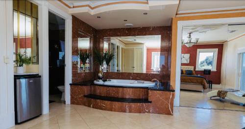 a bathroom with a tub and a large mirror at ABC Beachside Retreat in Rosebud