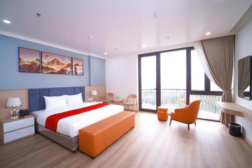 a bedroom with a large bed and a large window at Eden Luxury Hotel in Thái Bình