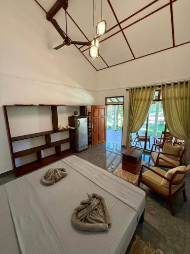 a bedroom with a large bed with two towels on it at 108 Palms Beach Resort in Trincomalee