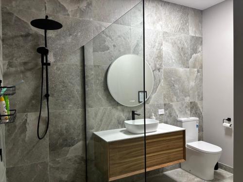 a bathroom with a sink and a mirror at Gala 1 - The Old Coolstore in Merricks North