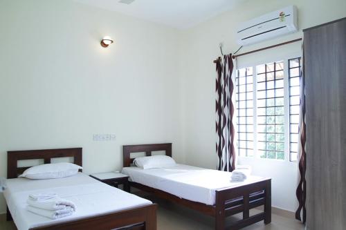 Ένα ή περισσότερα κρεβάτια σε δωμάτιο στο Fortbeach Service Apartments
