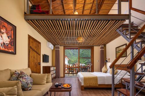 a living room with a loft bed and a staircase at YangShuo Coco Garden Villa-Western food&English Guide in Yangshuo