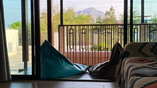 a person laying on the floor in front of a sliding glass door at Cha-am Mountain View Nature House 3 Bed 2 Bath in Phetchaburi