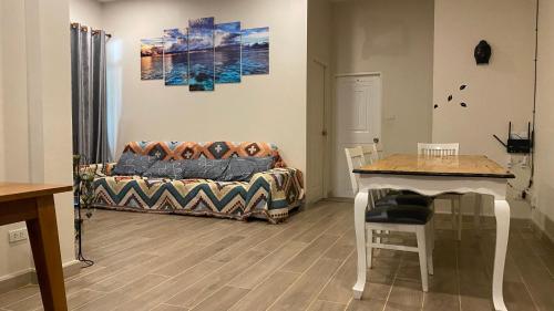 a living room with a couch and a table at Cha-am Mountain View Nature House 3 Bed 2 Bath in Phetchaburi