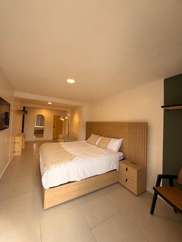 a bedroom with a large bed in a room at RA Suites in Tijuana