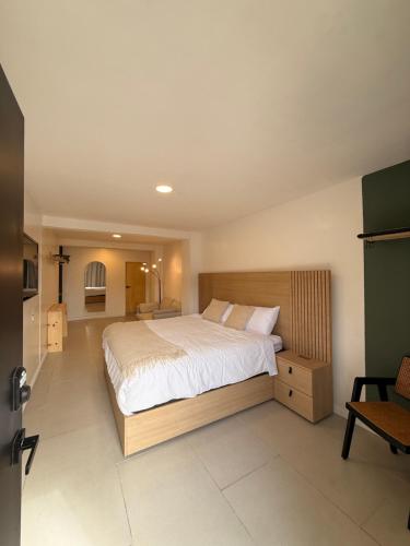a bedroom with a large bed in a room at RA Suites in Tijuana