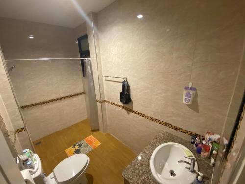 a bathroom with a shower and a toilet and a sink at Cha-am Mountain View Nature House 3 Bed 2 Bath in Phetchaburi