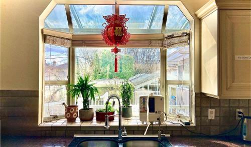 a large window in a room with plants in front of it at Private Ensuite Room Near YVR Airport Vancouver West in Vancouver