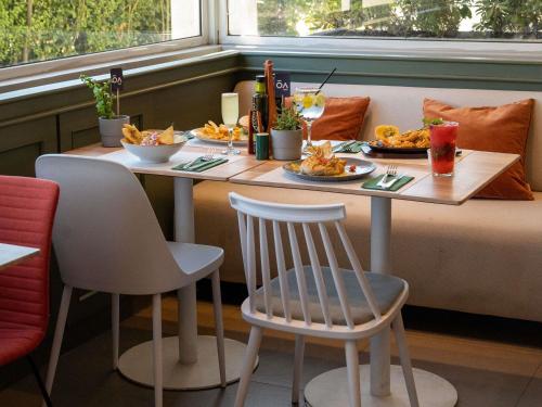 a table with plates of food on it in a restaurant at ibis Concepcion in Concepción