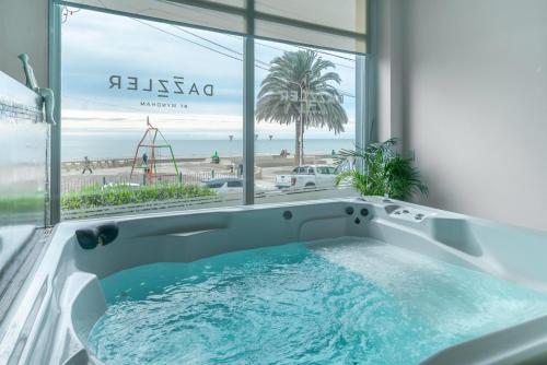 a bath tub with a view of the beach at Dazzler by Wyndham Puerto Madryn in Puerto Madryn
