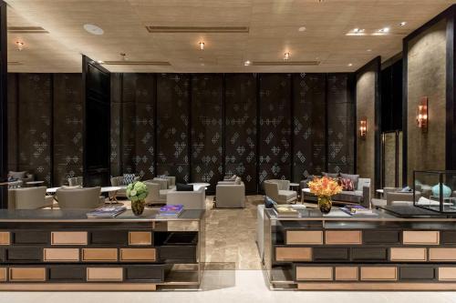 a restaurant with tables and chairs in a room at Hyatt Regency Bangkok Sukhumvit in Bangkok