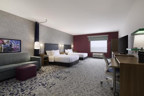 a hotel room with a bed and a desk at Home2 Suites by Hilton Stevens Point in Stevens Point