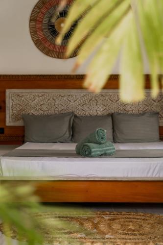 a bed with a stuffed animal sitting on it at ISOLA - Surf House in Ahangama