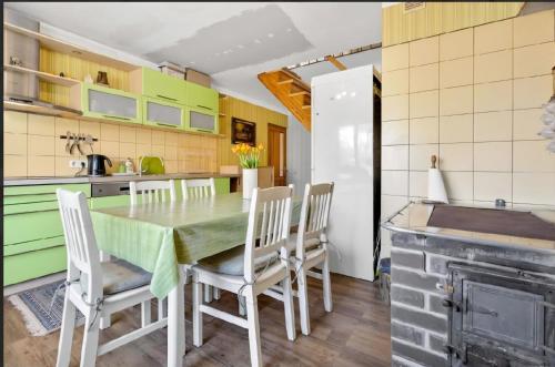 a kitchen and dining room with a table and chairs at Sweet Home in Koknese
