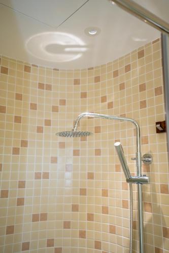 a bathroom with a shower with a shower head at Mộc Villa DaLat in Khu Chi Lăng
