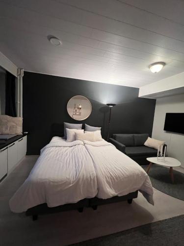 a bedroom with a large bed with a black wall at Top location in Joensuu in Joensuu