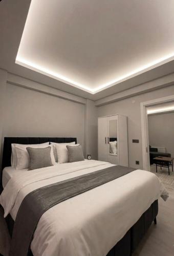 a bedroom with a large bed with a ceiling at Velora Suit Hotel in Nevşehir