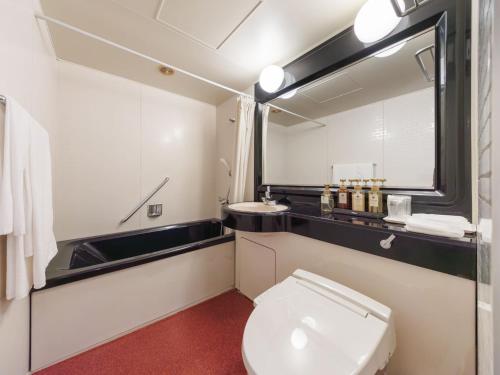 a bathroom with a white toilet and a sink at Hitachi Ocean View HOTEL and RESORT in Hitachi