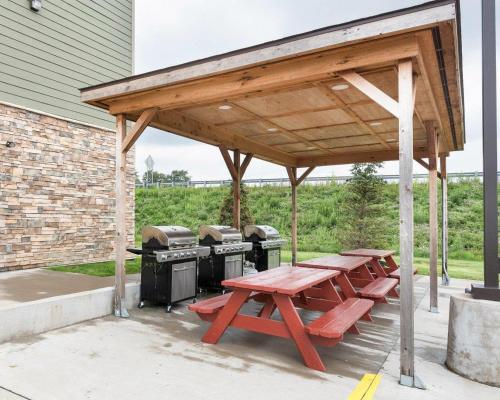 a picnic shelter with picnic tables and a grill at Suburban Studios Triadelphia - Wheeling at The Highlands in Triadelphia