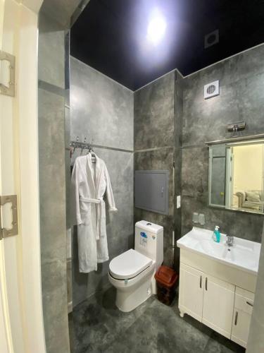 a bathroom with a toilet and a sink at Luxanda Samarkand in Samarkand