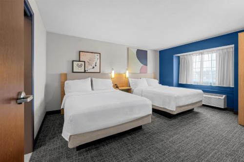 a hotel room with two beds and a window at Spark by Hilton Stillwater in Stillwater