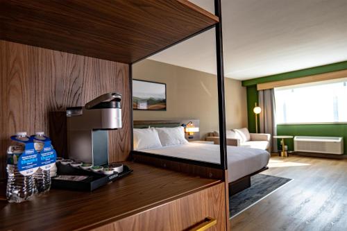 a hotel room with a bed and a couch at Hilton Garden Inn Clackamas Portland in Clackamas