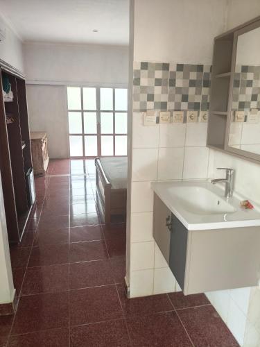 a bathroom with a sink and a bed in a room at Hotel SeaSide lovina in Lovina