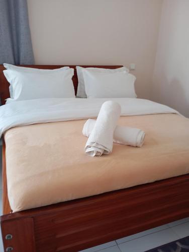 a bed with two white towels on it at The Elite havens in Nairobi